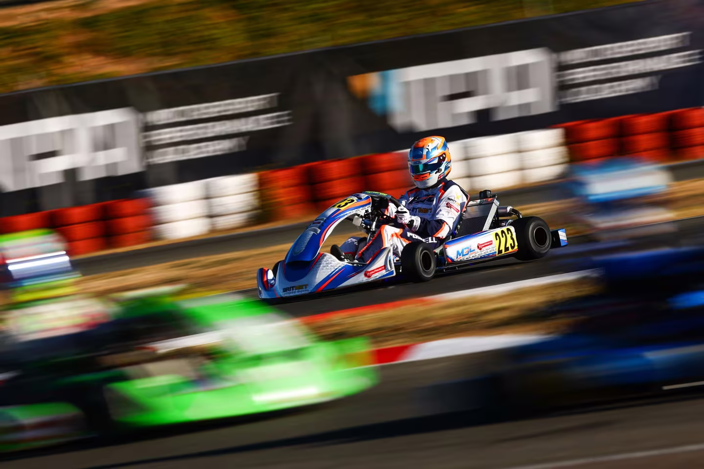 MDL Motorsport kart at speed on a race circuit